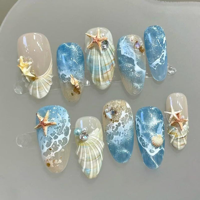 Blue seaside false nails, decorated false nails, seashell nail art, starfish nails, ocean-inspired nails, coastal nail designs, beach themed nails, Australian nail art